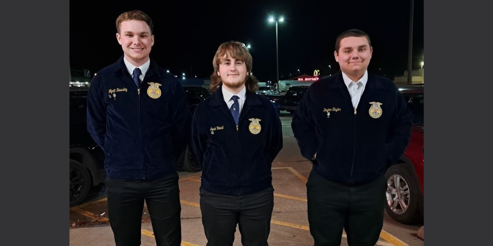 3 smiling young men in FFA blue jackets and black pants