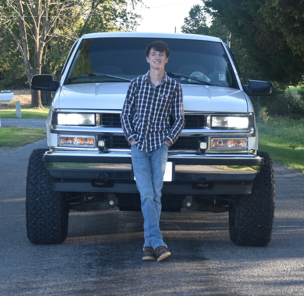 Senior boy in front of white truck