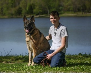 Senior boy picture with dog in front of water