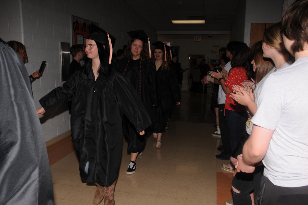 Students walking in caps and gowns