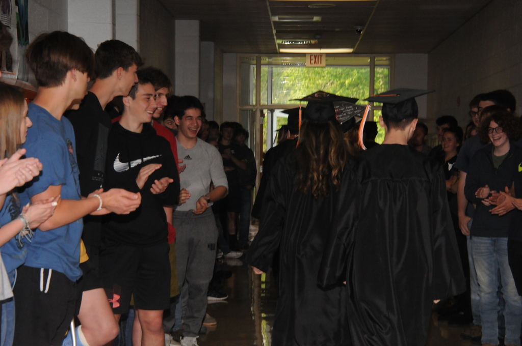 Students walking in caps and gowns