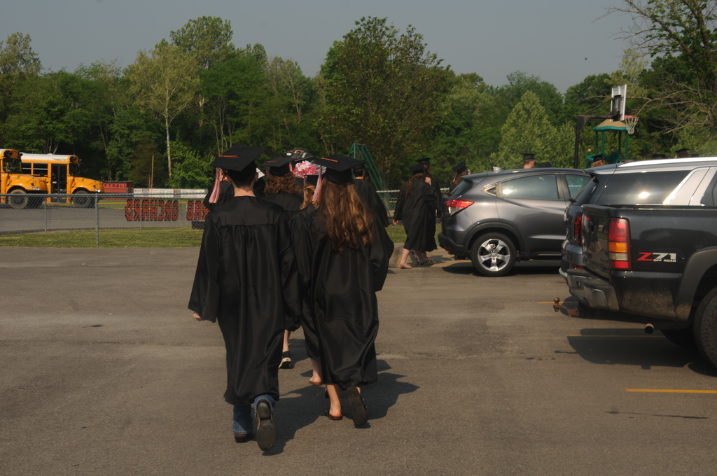 Seniors walking in caps and gowns