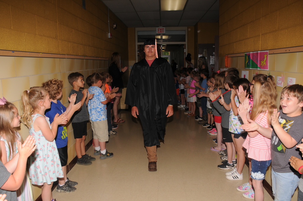 Seniors walking in caps and gowns