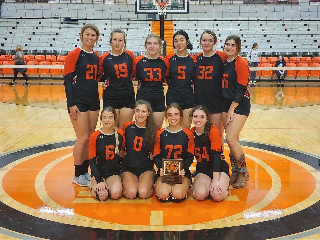 High school girls volleyball team with plaque